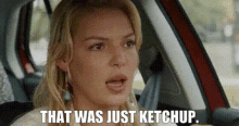 a woman is sitting in a car and saying `` that was just ketchup '' .