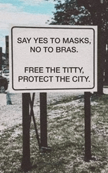 a sign that says yes to masks no to bras free the titty protect the city