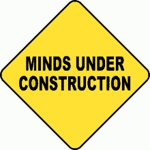 a yellow diamond shaped sign that says minds under construction