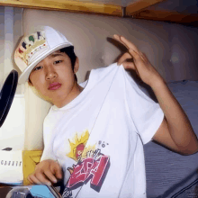 a boy wearing a hat and a t-shirt that says ' sleep ' on it