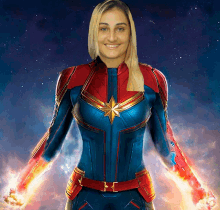 a woman in a captain marvel costume stands in front of a starry sky