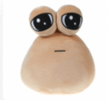 a stuffed animal with big eyes is sitting on a white background .