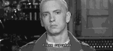 eminem is wearing a jacket and a necklace and says `` i love cupcakes '' .