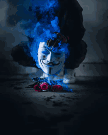 a anonymous mask is surrounded by blue smoke and roses