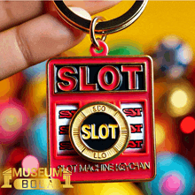 a person is holding a keychain with the word slot on it