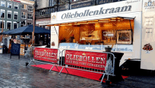 a food stand called oliebollenkraam has a red carpet in front of it