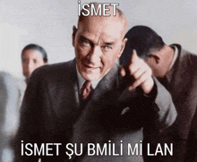 a man in a suit and tie is pointing at the camera with a caption that reads ismet