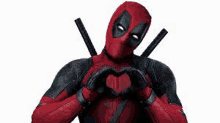 deadpool is making a heart shape with his hands and a sword .