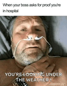 a man is laying in a hospital bed with a nasal cannula and ear buds