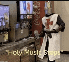 a man in a knight costume is holding a cup in front of a coca cola machine