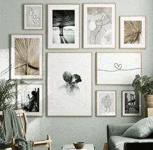 a living room with a lot of framed pictures on the wall including one of a man and woman kissing