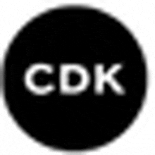 a black circle with the word cdk written in white letters .