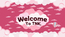 a welcome to tnk sign with pink clouds