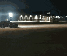 a car is driving down the road at night