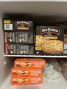 two boxes of red baron deep dish pizza sit on a shelf