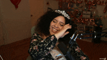 a woman wearing a tiara and a sash that says bridesmaid