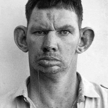 a black and white photo of a man with big ears