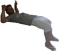 a man in a grey shirt and white shorts is laying on his back and giving a peace sign