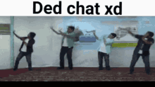 a group of men are dancing in front of a wall that says ded chat xd on it