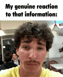 a man with curly hair and a mustache has a genuine reaction to that information