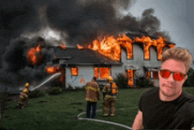 a man is standing in front of a burning house