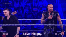 two men in a wrestling ring with the words love this guy on the bottom