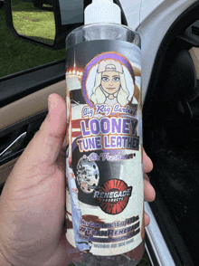 a person holding a bottle of looney tune leather