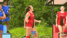 a group of female athletes are standing in a field and one of them has the name pamela on her shirt