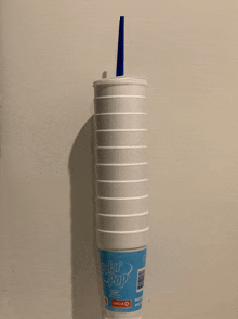 a polar pop cup with a blue straw on it