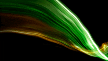 a green and yellow swirl of light on a black background