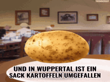 a potato on a white plate with the words " und in wuppertal ist ein sack kartoffeln umgefallen "