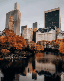 a cityscape with a lake in the foreground and a hotel in the background