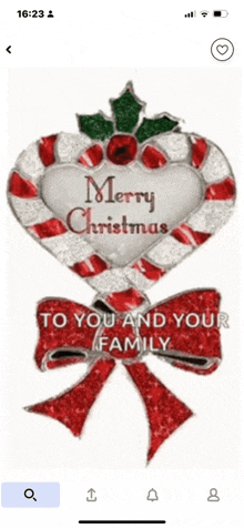 a phone screen shows a candy cane in the shape of a heart with the words merry christmas to you and your family