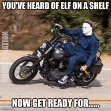 a person in a mask is riding a motorcycle on a road .