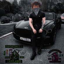 a man wearing a bandana is standing in front of a black car