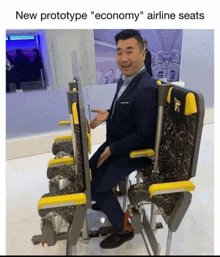 a man in a suit sits in a row of airline seats