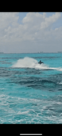 a person is riding a jet ski on the ocean