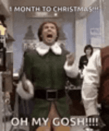 a man in a green elf costume is standing in a hallway and screaming .