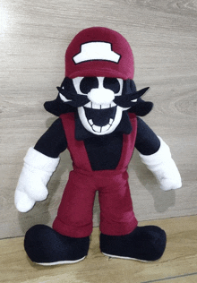 a stuffed mario with a hat and mustache