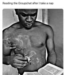 a black and white photo of a shirtless man smoking a cigarette while reading a book