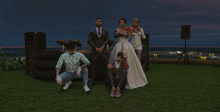 a bride and groom pose for a picture with their friends