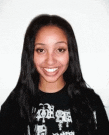 a young woman wearing a black shirt that says ' i love you ' on it smiles for the camera