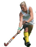 a woman is holding a grays hockey stick in her right hand