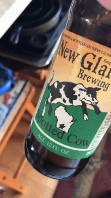 a bottle of new glare brewing spotted cow ale 12 fl oz