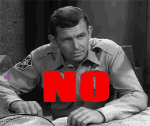 a man in a sheriff 's uniform has the word no on his chest