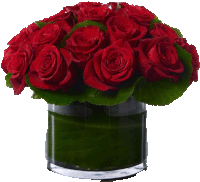 a glass vase filled with red roses and greenery