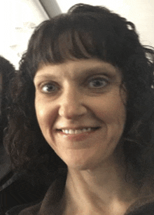 a close up of a woman 's face smiling