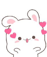 a white bunny with pink hearts on its ears