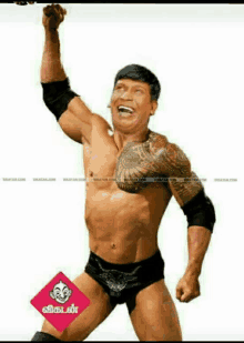 a shirtless man with a tattoo on his chest is holding his fist up in the air