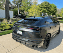 a gray lamborghini is parked on a sidewalk